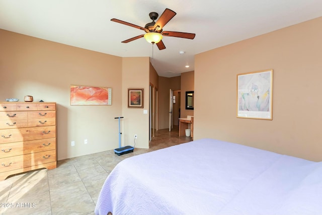 tiled bedroom with ceiling fan and ensuite bath