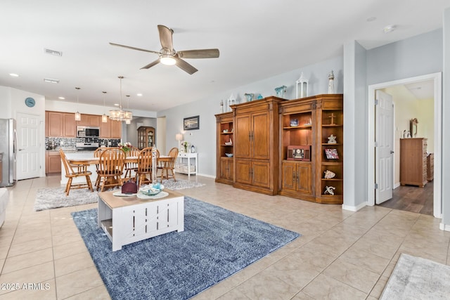 28883 N 131st Dr, Peoria, AZ 85383 - living area with light tile patterned flooring, recessed lighting, ceiling fan with notable chandelier, visible vents, and baseboards