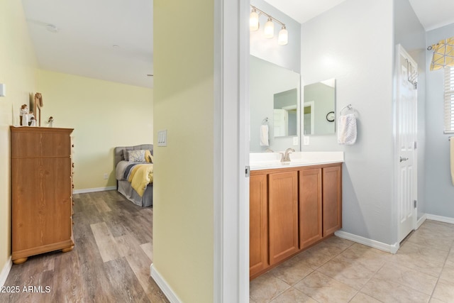 28883 N 131st Dr, Peoria, AZ 85383 - ensuite bathroom featuring ensuite bath, baseboards, wood finished floors, and vanity