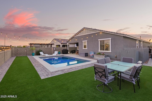 28883 N 131st Dr, Peoria, AZ 85383 - pool at dusk with a fenced in pool, a fenced backyard, a lawn, and a patio
