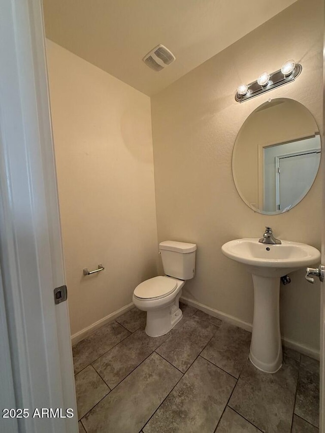 bathroom featuring tile patterned floors and toilet