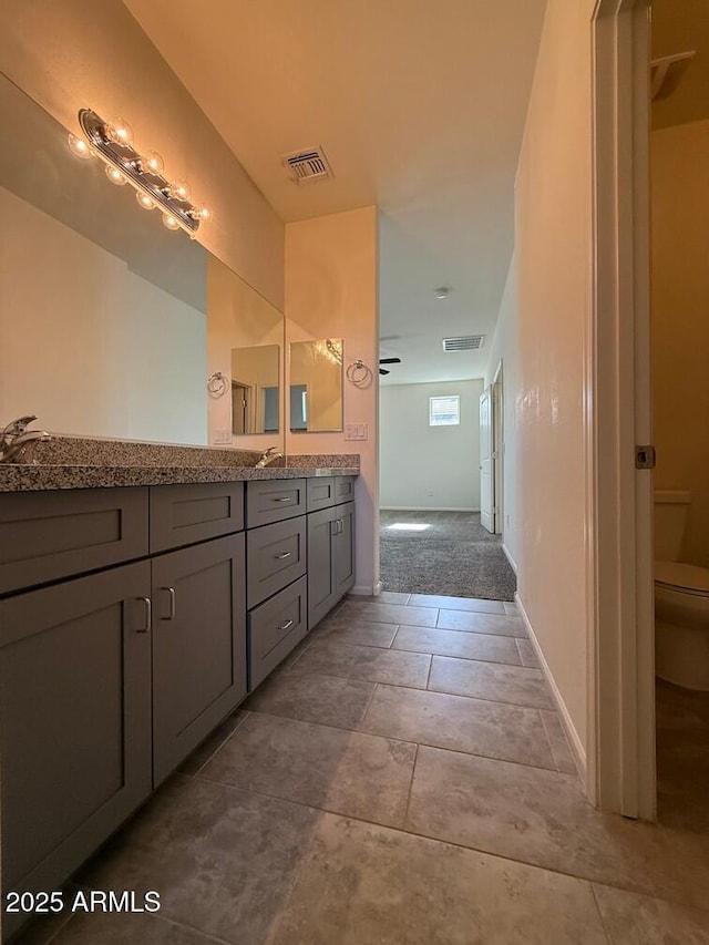 bathroom with vanity and toilet