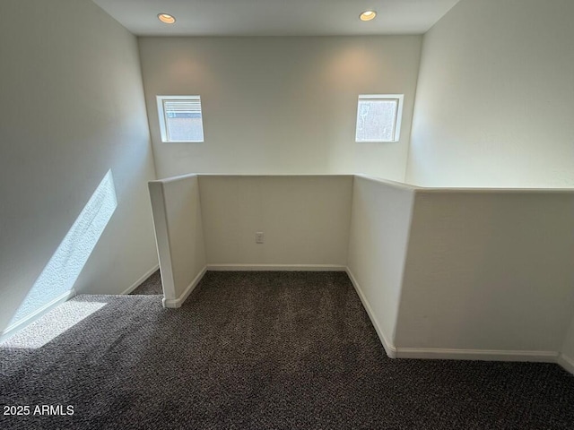 spare room featuring dark carpet