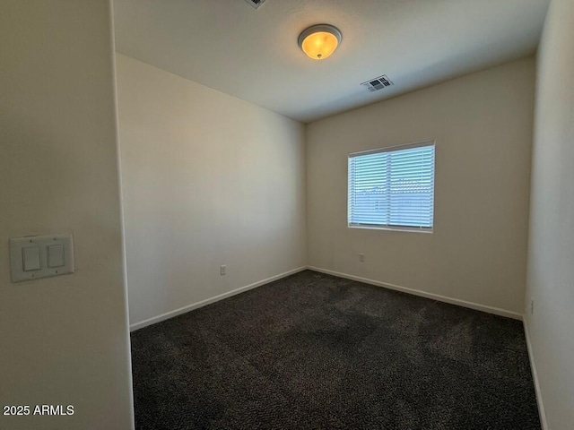 unfurnished room with dark colored carpet