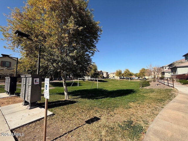 view of property's community with a lawn and mail boxes