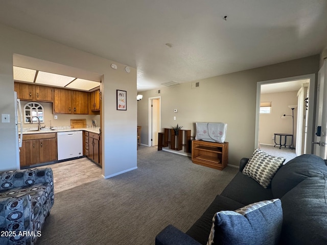 carpeted living room with sink