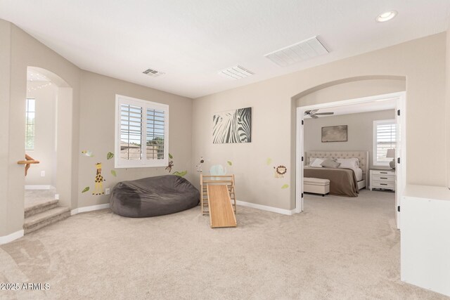 6870 S Crestview Dr, Gilbert, AZ 85298 - sitting room with arched walkways, light carpet, healthy amount of natural light, baseboards, and recessed lighting