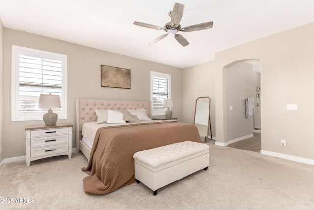 6870 S Crestview Dr, Gilbert, AZ 85298 - bedroom featuring arched walkways, light carpet, baseboards, and a ceiling fan