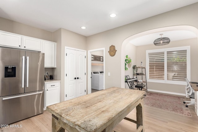 6870 S Crestview Dr, Gilbert, AZ 85298 - kitchen with stainless steel fridge with ice dispenser, arched walkways, washer / clothes dryer, light wood-type flooring, and recessed lighting