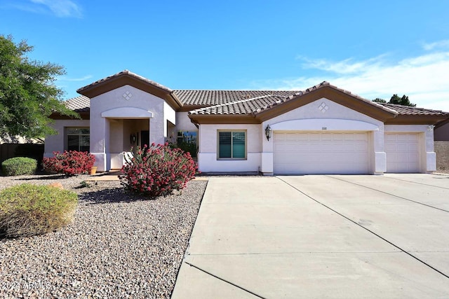 mediterranean / spanish-style home with a garage