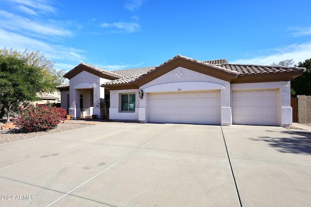 mediterranean / spanish-style house featuring a garage