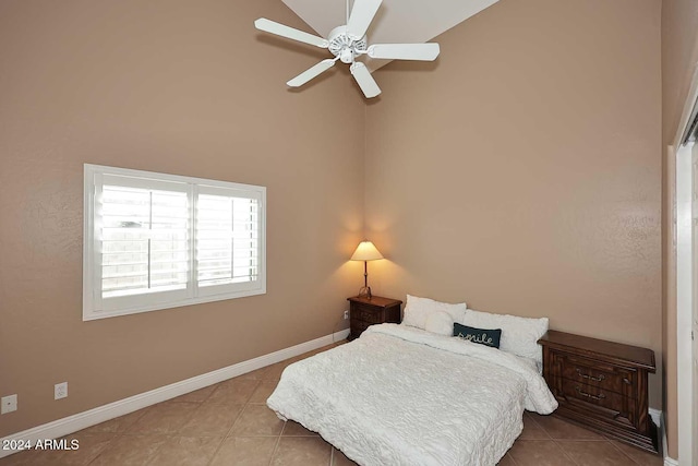 tiled bedroom featuring ceiling fan and vaulted ceiling