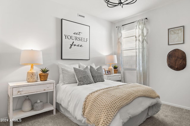 carpeted bedroom with visible vents and baseboards