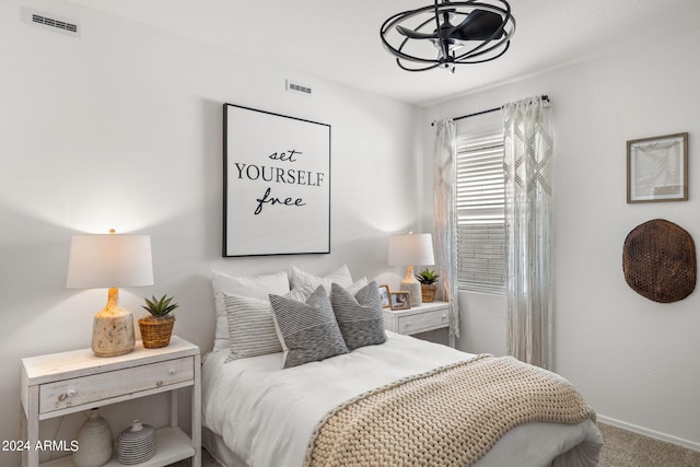 carpeted bedroom with visible vents and baseboards