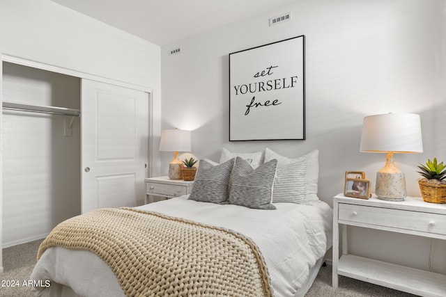 carpeted bedroom featuring a closet, baseboards, and visible vents