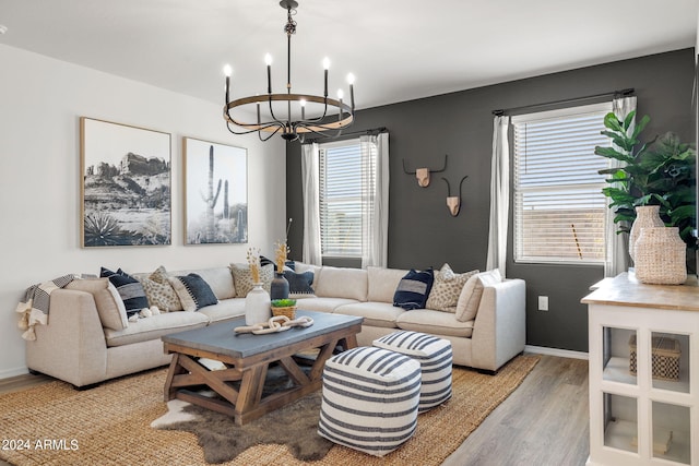 living area featuring a notable chandelier, plenty of natural light, and light wood-style floors