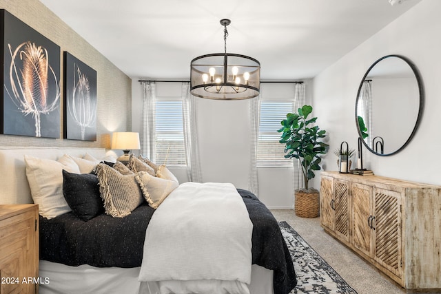 bedroom with light carpet and an inviting chandelier