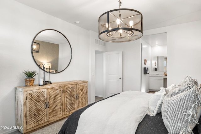 bedroom featuring a notable chandelier, connected bathroom, and visible vents