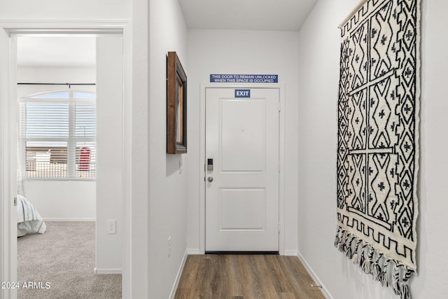 entryway with wood finished floors and baseboards