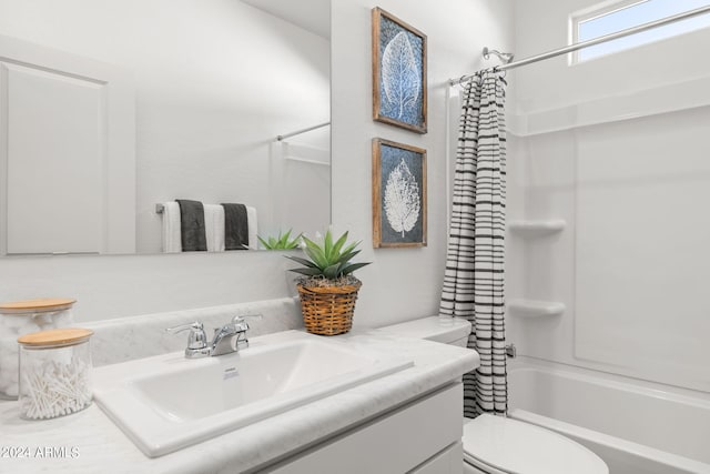 bathroom with toilet, vanity, and shower / tub combo