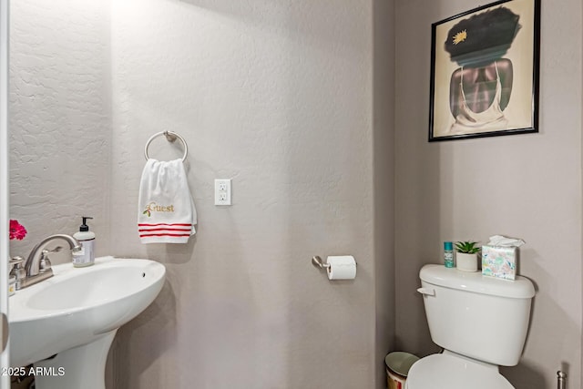 bathroom featuring toilet and a sink