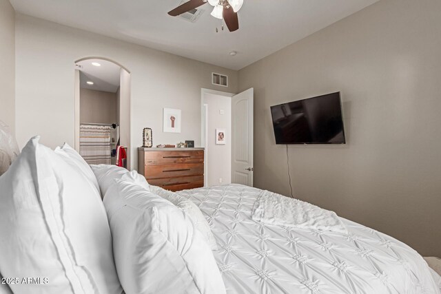 bedroom featuring ceiling fan, arched walkways, visible vents, and recessed lighting