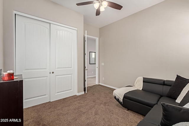 carpeted living area with ceiling fan and baseboards