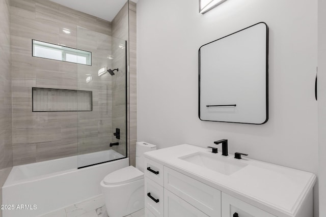 2122 W Virginia Ave, Phoenix, AZ 85009 - bathroom featuring marble look tile flooring, vanity, toilet, and bath / shower combo with glass door