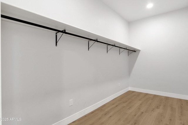 2122 W Virginia Ave, Phoenix, AZ 85009 - walk in closet with light wood-style flooring