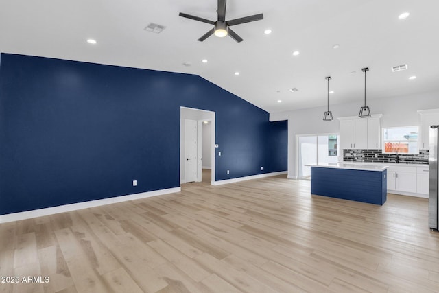 2122 W Virginia Ave, Phoenix, AZ 85009 - unfurnished living room featuring a ceiling fan, a sink, lofted ceiling, recessed lighting, and light wood-style floors
