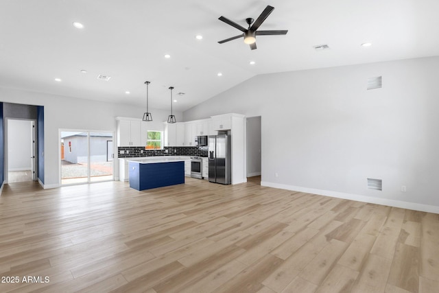 2122 W Virginia Ave, Phoenix, AZ 85009 - kitchen with appliances with stainless steel finishes, open floor plan, a kitchen island, light countertops, and ceiling fan