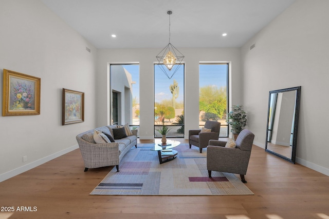 living room featuring hardwood / wood-style floors and a notable chandelier