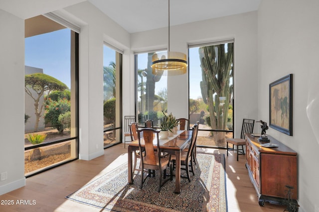 dining room featuring a notable chandelier and light wood-type flooring