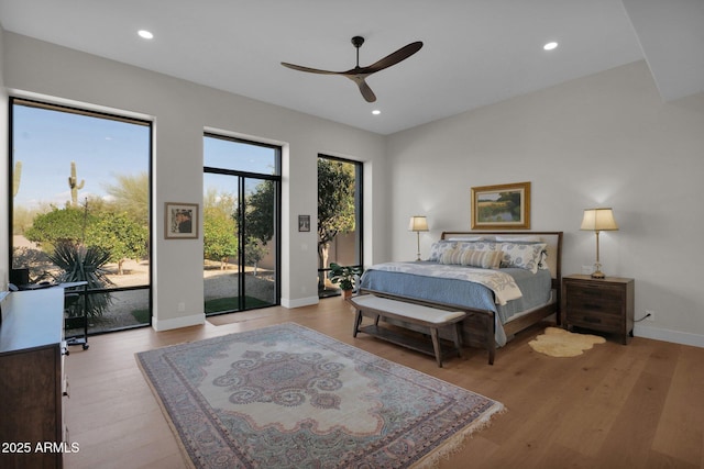 bedroom featuring access to outside, ceiling fan, and light hardwood / wood-style flooring