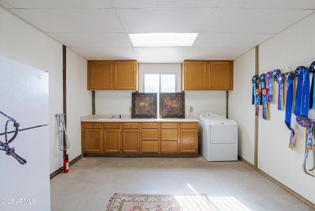 laundry area with washer / clothes dryer, sink, and cabinets