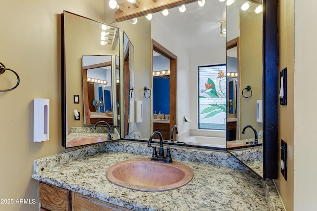 bathroom featuring vanity and a bath