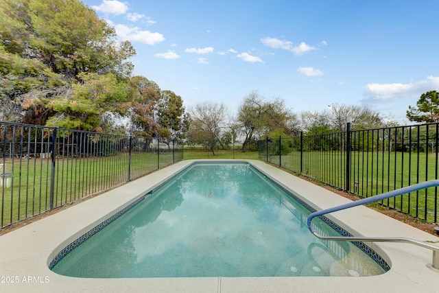 view of pool featuring a lawn and a fenced backyard