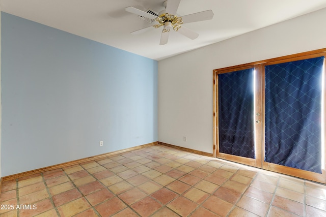 spare room with baseboards and ceiling fan