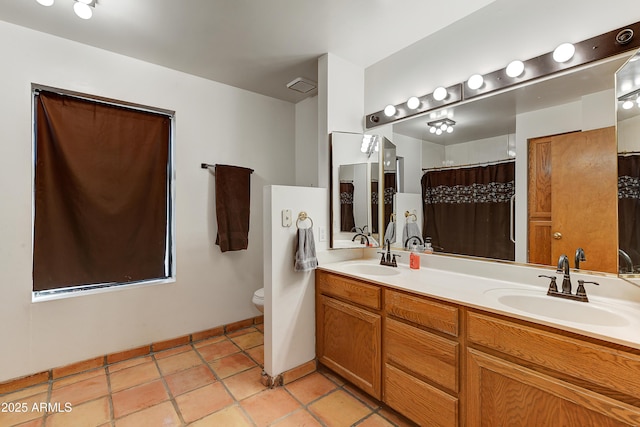 bathroom featuring tile patterned flooring, visible vents, toilet, and a sink