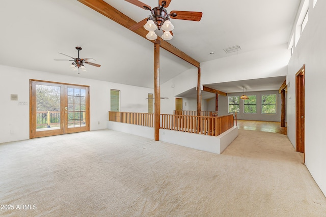 unfurnished room featuring beam ceiling, carpet flooring, a healthy amount of sunlight, and ceiling fan