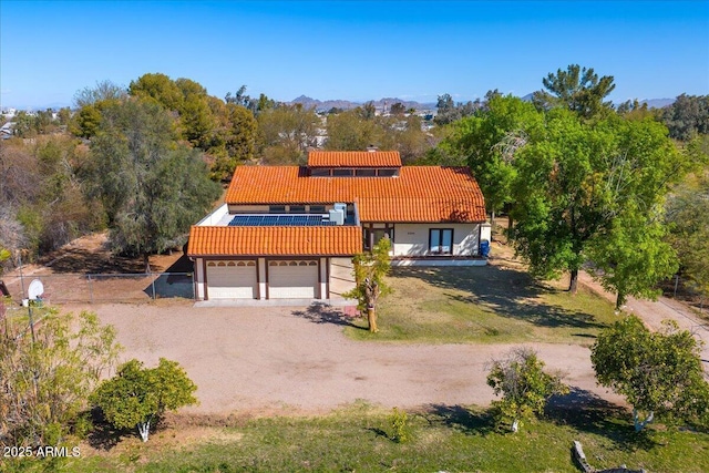3264 E Vineyard Rd, Phoenix, AZ 85042 - view of front of house with fence, an attached garage, stucco siding, dirt driveway, and a tiled roof