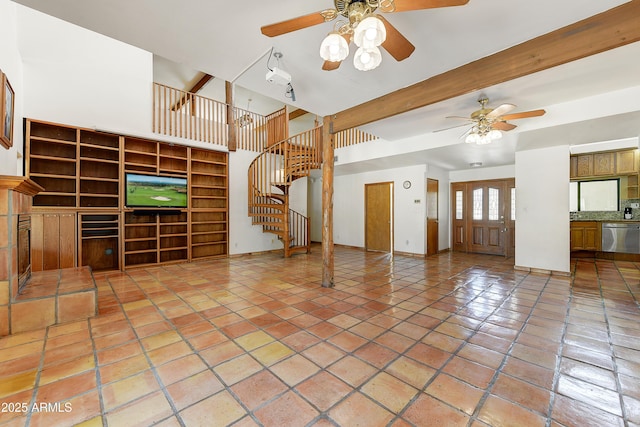 unfurnished living room with beamed ceiling, stairway, light tile patterned flooring, a fireplace, and ceiling fan