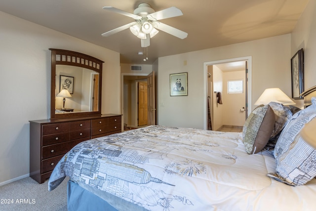 carpeted bedroom with ceiling fan and connected bathroom