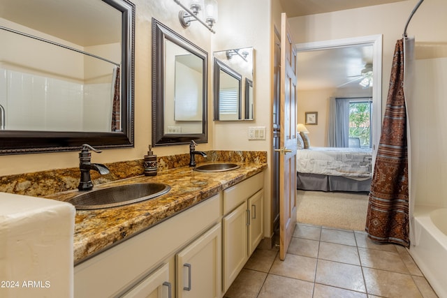 bathroom with ceiling fan, vanity, tile patterned flooring, and shower / bath combo with shower curtain