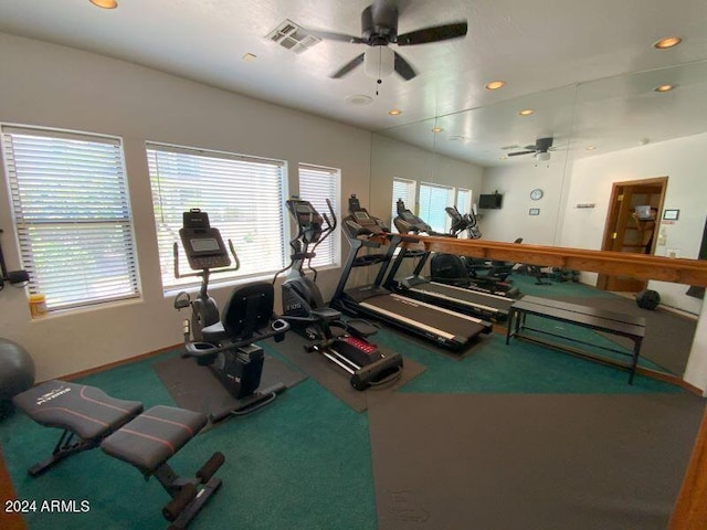 gym featuring ceiling fan and carpet floors