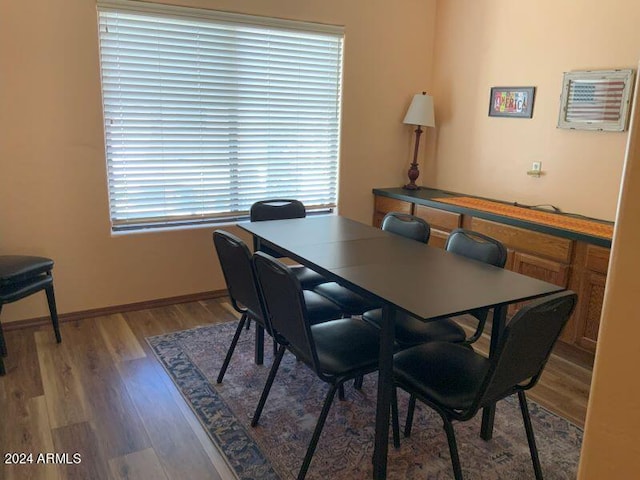 dining space with hardwood / wood-style floors