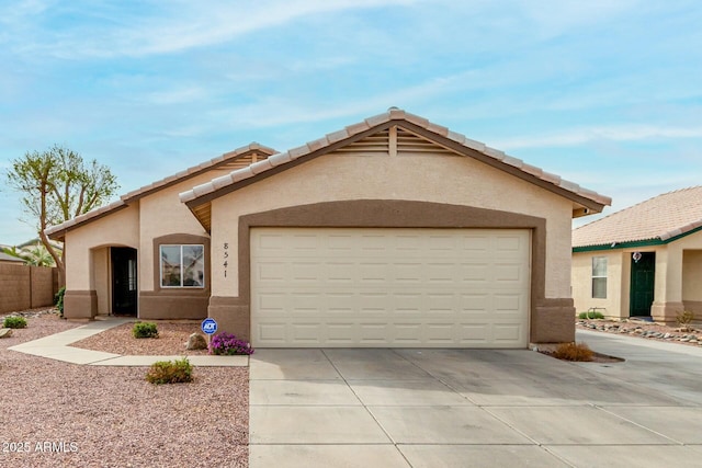 ranch-style home featuring a tile roof, driveway, an attached garage, and stucco siding