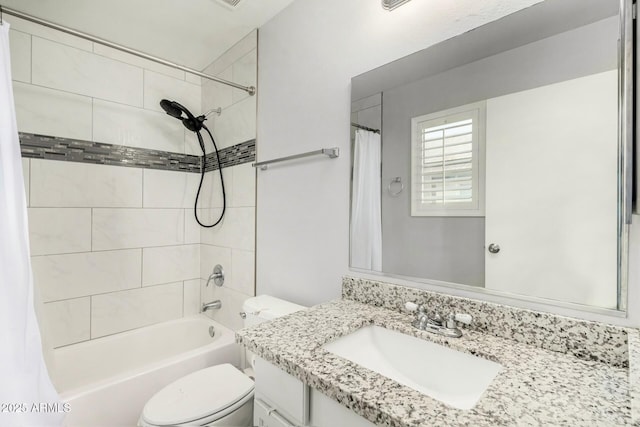 full bath featuring vanity, shower / bath combo with shower curtain, and toilet