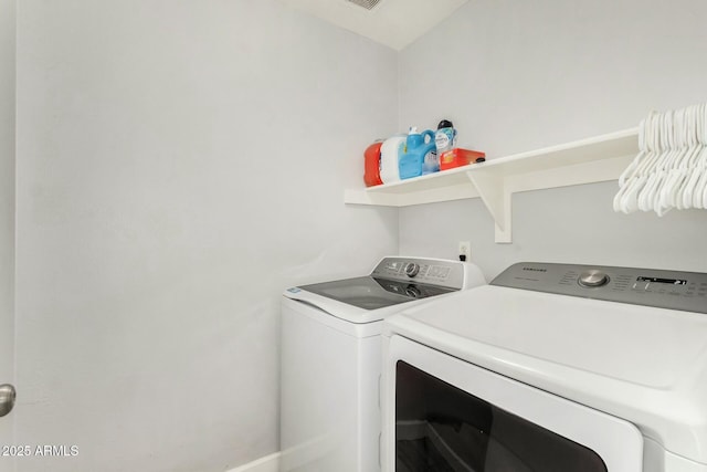 clothes washing area with washing machine and dryer and laundry area