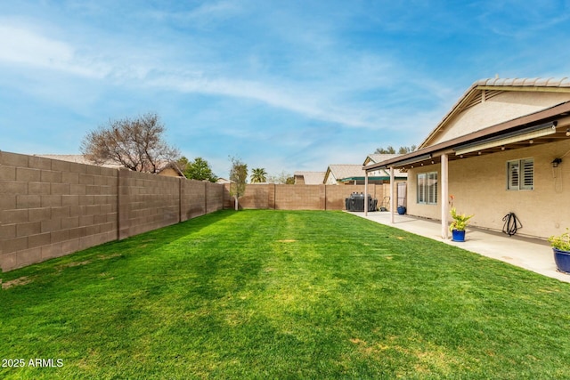 view of yard featuring a patio and a fenced backyard